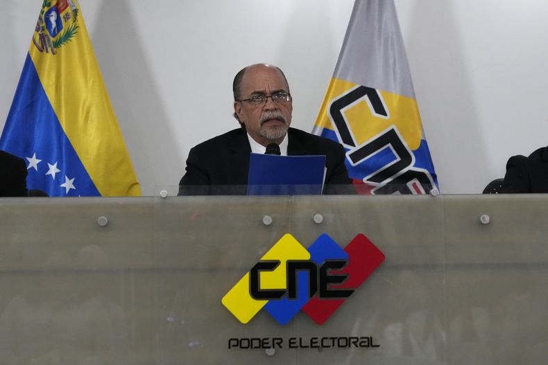 Pedro Calzadilla, president of the National Electoral Council (CNE), center, announces the resignation of members of the council's board in Caracas, Venezuela, Thursday, June 15, 2023. (AP Photo/Ariana Cubillos)