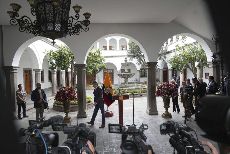 Ecuador's President Guillermo Lasso leaves after giving a news conference at the Carondelet presidential palace in Quito, Ecuador, Friday, June 2, 2023. Lasso, who dissolved the National Assembly two weeks earlier, announced that he would not He will run for presidential re-election in the next elections on August 20.  (AP Photo/Dolores Ochoa)