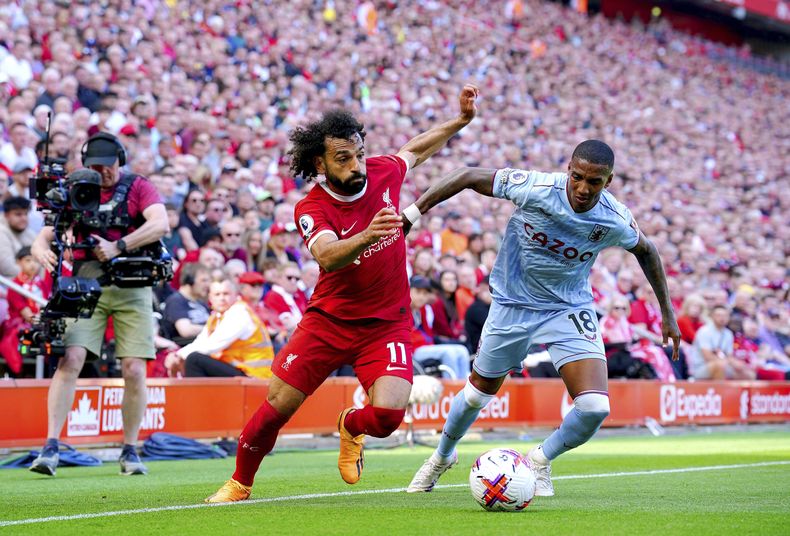 Mohamed Salah del Liverpool y Ashley Young del Aston Villa pelea por el balón en el encuentro de la Liga Premier el sábado 20 de mayo del 2023. (Peter Byrne/PA via AP)
