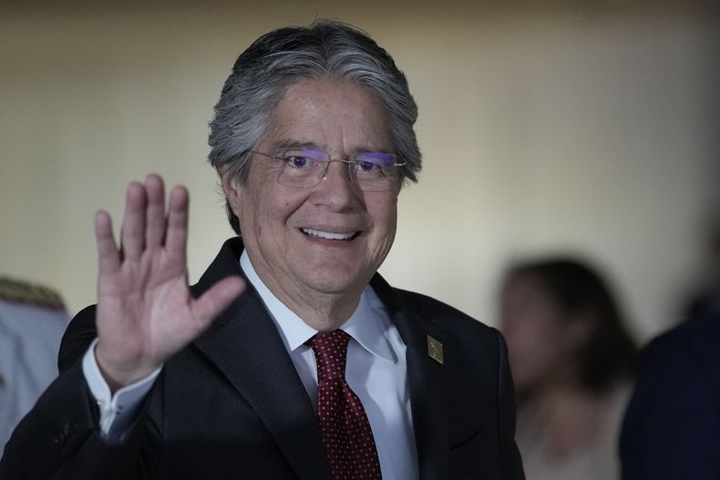 Ecuador's President Guillermo Lasso greets the media after attending the South American Summit at the Itamaraty Palace in Brasilia, Brazil, Tuesday, May 30, 2023. Lasso announced on June 2, 2023 that he will not participate as a candidate for the presidential re-election in the anticipated elections, after his decision to dissolve the Assembly and shorten his term.  (AP Photo/Andre Penner)